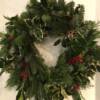 Traditional Christmas door wreath full of festive foliage and red berries